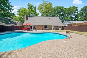 a swimming pool in front of a house at Close to St. Francis Hospital • 4 Smart Tvs • Pool • Patio in Tulsa