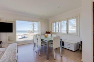 uma sala de jantar com uma mesa e cadeiras com vista para o oceano em Beachfront MIAMI 2 Bdr Easy Living VIEWS VIEWS!!!! em Gold Coast