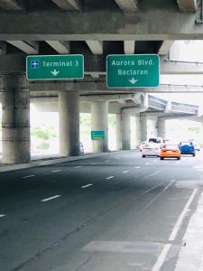 a highway with freeway signs and cars on the road at THE MANSION - 2 PAX SOLO BUDGET Room near AIRPORT TERMINAL in Manila