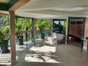 a screened porch with a couch and a piano at Hin Wong Apartments Dive & Snorkel Resort in Koh Tao +197 photos