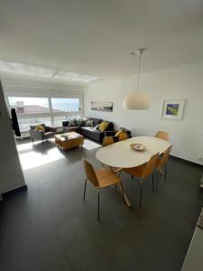 a living room with a table and a couch at Viva Sitges - Sitges View in Sitges