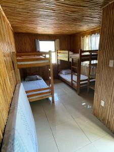 a small room with two bunk beds in it at West Sahara Beach House in Cabangan