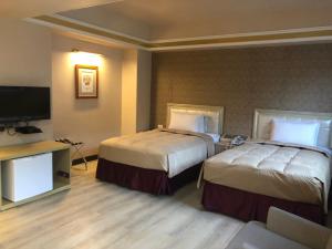 Postel nebo postele na pokoji v ubytování Doitsu Hotel