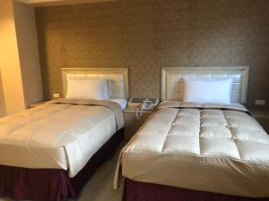 Postel nebo postele na pokoji v ubytování Doitsu Hotel