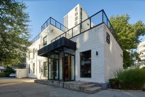 a white brick building with a metal staircase on top at Yi Stack Hotel Beijing in Beijing
