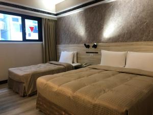 Postel nebo postele na pokoji v ubytování Doitsu Hotel