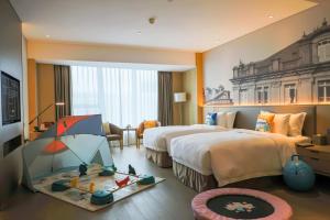 Voodi või voodid majutusasutuse Wyndham Grand Plaza Royale Yuzhou Xiamen Wuyuan Bay toas