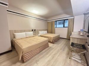 Postel nebo postele na pokoji v ubytování Doitsu Hotel