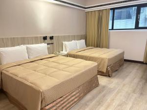 Postel nebo postele na pokoji v ubytování Doitsu Hotel