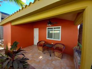 a patio with chairs and a table in a house at Coco Cabanas Loreto in Loreto