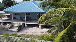 an aerial view of a house with a blue roof at LE FARE BLEU Tiputa Rangiroa in Tiputa
