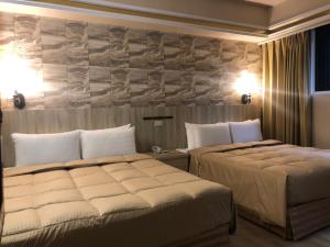 Postel nebo postele na pokoji v ubytování Doitsu Hotel