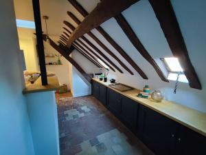 an attic kitchen with wooden beams and a counter top at Magnifique Appartement Beaux arts in Tours
