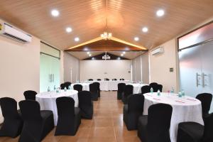 a banquet hall with tables and chairs in a room at Arova Woods Zinc Journey by The Fern, Lonavala in Lonavala