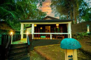 a house with a blue mushroom on the porch at La La Land Resort Goa by Spicy Mango in Palolem