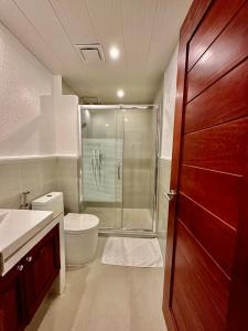 a bathroom with a toilet and a glass shower at Calypso Beach and Dive Resort in Boracay