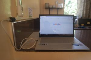 a laptop computer sitting on top of a counter at Yoo C Apartment in Dumaguete