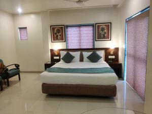 a bedroom with a large bed in a room at Masara Biznotel in Chakan