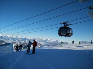 a group of people on a ski lift at a ski slope at Amis apartmán 2 in Liptovský Trnovec