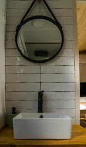 ein Waschbecken mit einem Spiegel an der Wand in der Unterkunft Casa Pinar del Eden Sur in Chiclana de la Frontera