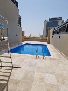 a swimming pool on the roof of a building at Grand Stay Holiday Homes Al Jaddaf in Dubai