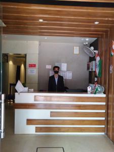a man wearing sunglasses behind a counter in an airport at Hotel MEGHA INN in Lucknow