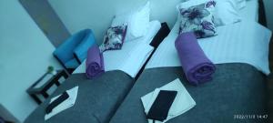 ein Bett mit Kissen und lila Krawatten darauf in der Unterkunft Bed and Breakfast M Jasmin in Sarajevo