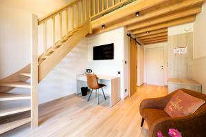 a living room with a desk and a staircase at B&B 't Motjeshof in Tielt