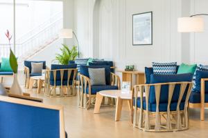 a waiting room with blue chairs and tables at Outrigger Koh Samui Beach Resort - SHA Extra Plus in Lamai