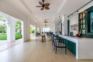 a lobby with a bar with green and white at Outrigger Koh Samui Beach Resort - SHA Extra Plus in Lamai