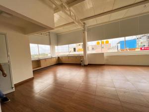 an empty room with a large window and a wooden floor at Hotel Sterling Inn in Bangalore