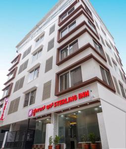 a building with a sign that reads bright apartment strengthening inn at Hotel Sterling Inn in Bangalore