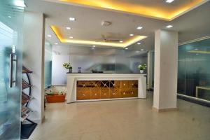 a lobby with a reception desk in a building at ECKO Sterling Inn Near Bangalore International Airport in Bangalore