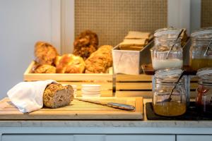 a cutting board with a loaf of bread and other pastries at Outrigger Koh Samui Beach Resort - SHA Extra Plus in Lamai