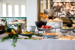 a buffet with fruits and vegetables on a table at Outrigger Koh Samui Beach Resort - SHA Extra Plus in Lamai