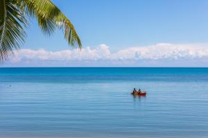 a group of people in a boat in the ocean at Outrigger Koh Samui Beach Resort - SHA Extra Plus in Lamai
