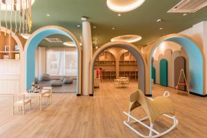 a room with blue and white arches and chairs at Outrigger Koh Samui Beach Resort - SHA Extra Plus in Lamai