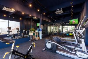a gym with treadmills and elliptical machines at Outrigger Koh Samui Beach Resort - SHA Extra Plus in Lamai