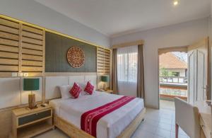 a bedroom with a large bed and a window at Baleka Resort & Spa in Legian