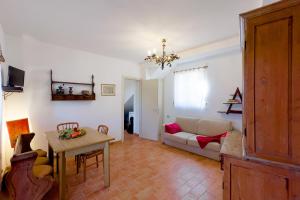a living room with a couch and a table at Villa Caterina Quiete e Mare-Goelba in SantʼAndrea
