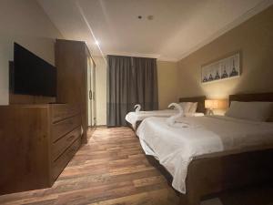 Ένα ή περισσότερα κρεβάτια σε δωμάτιο στο Wakra Inn Hotel Apartments