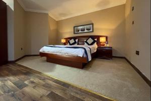 Ένα ή περισσότερα κρεβάτια σε δωμάτιο στο Wakra Inn Hotel Apartments