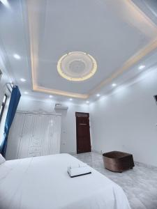 a bedroom with a large bed with a ceiling at Villa Blueware - Venuestay in Vĩnh Phúc