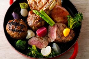 a pan filled with meat and vegetables on a table at Hyatt Regency Yokohama in Yokohama