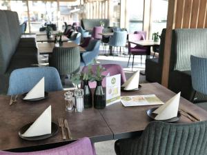 a table with paper napkins on it in a restaurant at Reos Hotel Wangen in Wangen im Allgäu