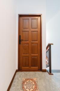 a wooden door with a rug in front of it at Botan Boutique Hotel in Patong Beach