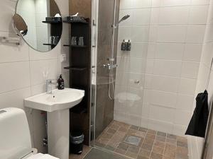 a bathroom with a shower and a sink and a toilet at Ombergs Golf Resort in Ödeshög