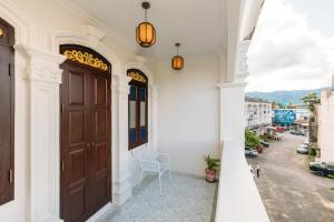 a door to a building with a view of a street at Botan Boutique Hotel in Patong Beach