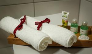 two rolls of toilet paper on a wooden shelf at Apartment Serenade am Zwinger in Goslar