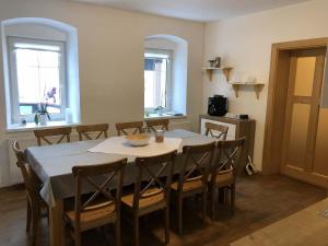 a dining room with a table and some chairs at Chalupa Měděnecká in Kovářská